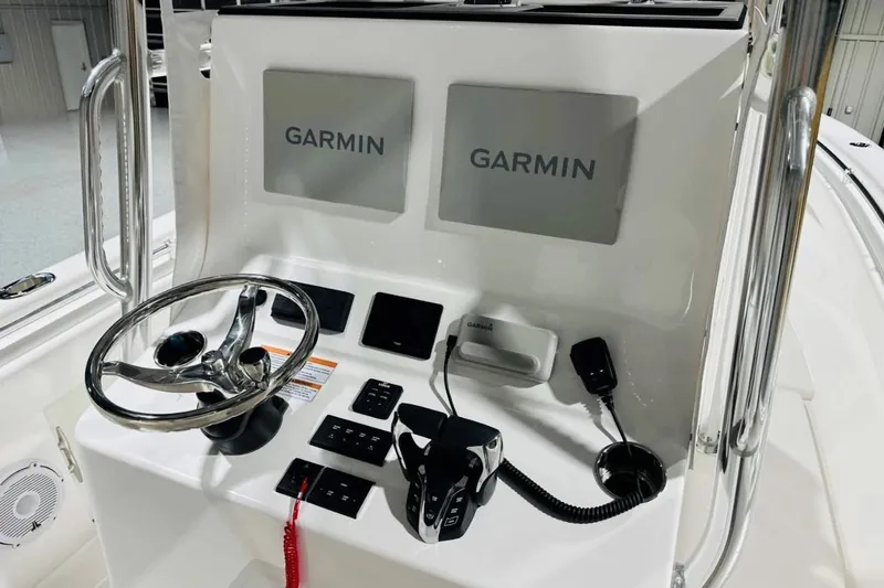 Slide: The Image of 2025 Contender 28 Tournament boat console with dual Garmin displays and steering wheel. - 2