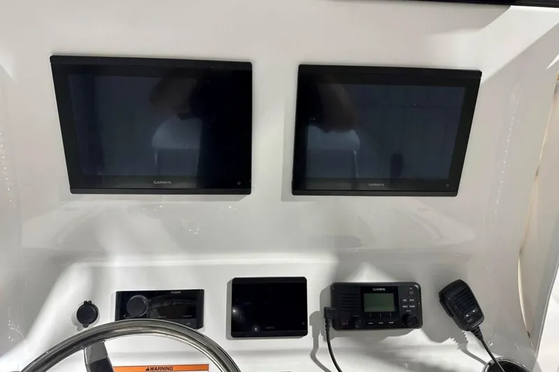 Slide: The Image of Dashboard of 2025 Contender 28 Tournament boat with Garmin displays and controls. - 4