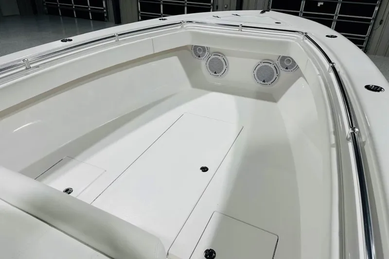 Slide: The Image of 2025 Contender 28 Tournament boat interior with sleek white design and built-in speakers. - 9