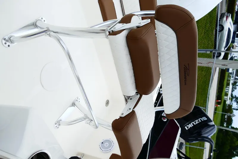 Slide: The Image of 2026 Pioneer 220 Bay Sport boat seat with brown and white upholstery. - 10