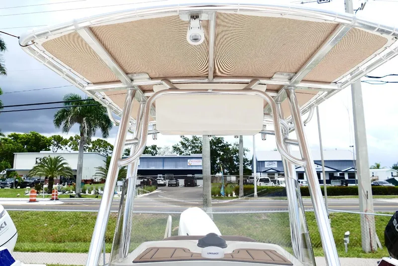 Slide: The Image of 2026 Pioneer 220 Bay Sport boat with T-top and modern design. - 15