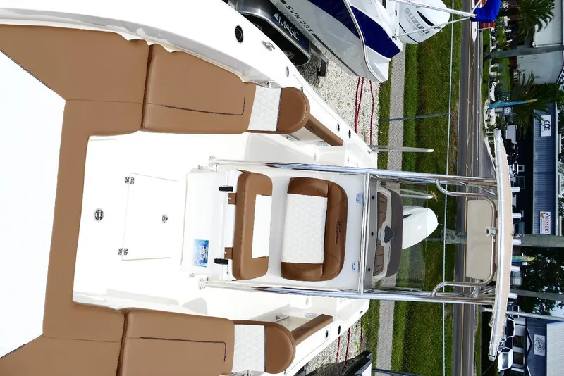 Slide: The Image of 2026 Pioneer 220 Bay Sport boat with tan seating and sleek design. - 17