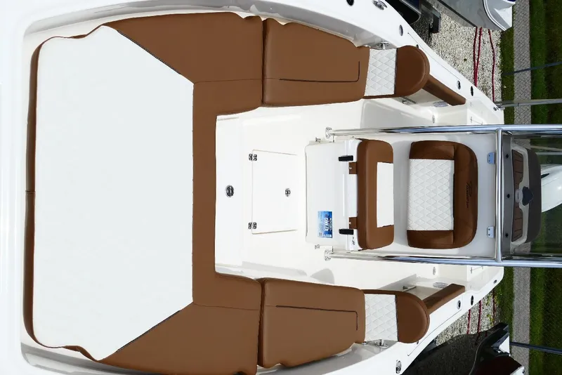 Slide: The Image of 2026 Pioneer 220 Bay Sport boat interior with brown and white seating. - 18