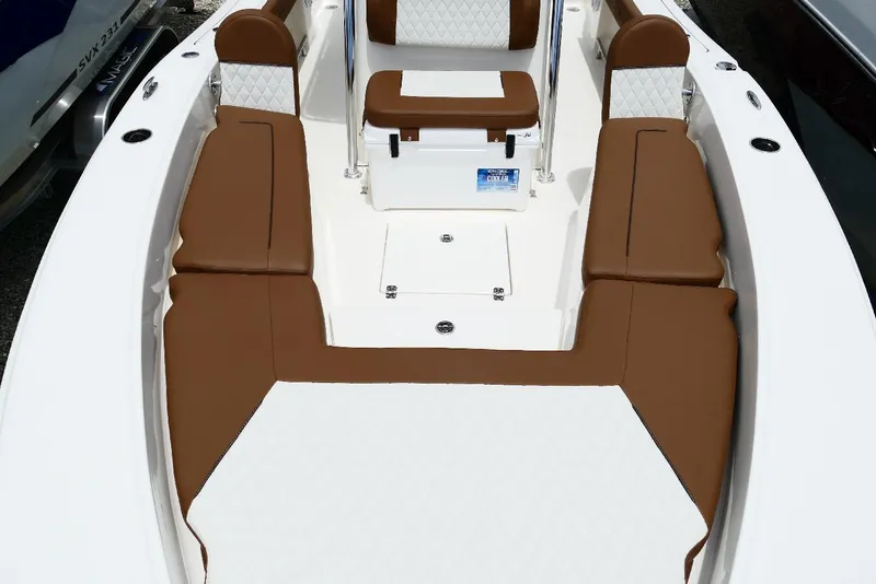 Slide: The Image of 2026 Pioneer 220 Bay Sport boat interior with brown and white seating. - 19