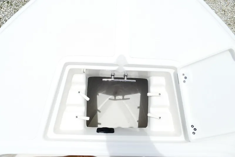 Slide: The Image of 2026 Pioneer 220 Bay Sport boat storage compartment, open lid, white interior. - 20