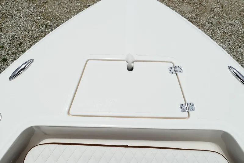 Slide: The Image of 2026 Pioneer 220 Bay Sport boat deck with storage hatch and stainless steel fittings. - 21