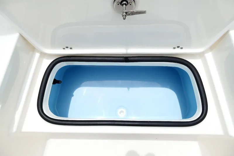 Slide: The Image of Livewell compartment on 2026 Pioneer 220 Bay Sport boat, featuring a blue interior. - 22