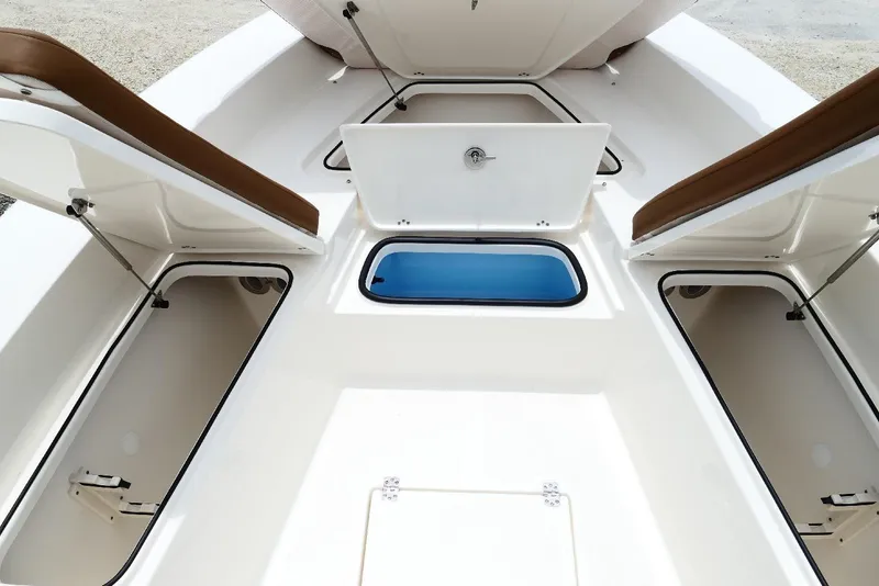 Slide: The Image of 2026 Pioneer 220 Bay Sport boat storage compartments and seating area. - 26