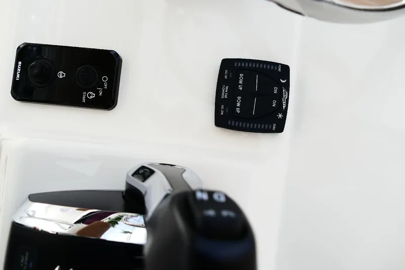 Slide: The Image of Control panel of 2026 Pioneer 220 Bay Sport boat with Suzuki and trim controls. - 35