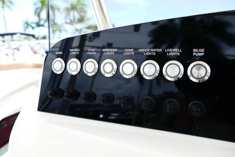Slide: The Image of Control panel of 2026 Pioneer 220 Bay Sport boat with various switches and buttons. - 37