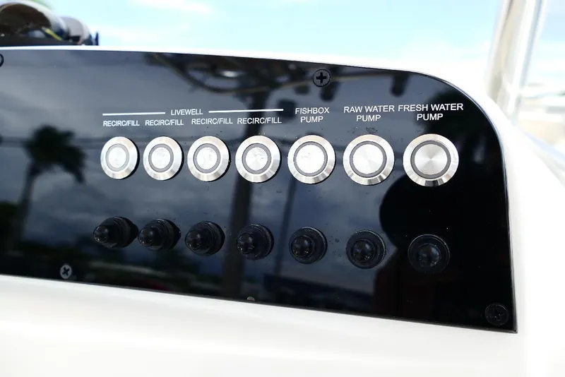 Slide: The Image of Control panel of 2026 Pioneer 220 Bay Sport boat with various pump switches. - 38