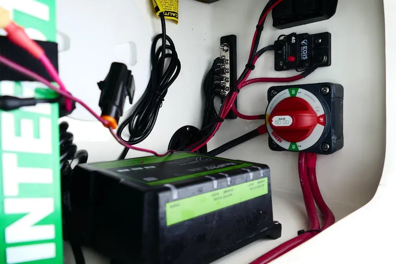 Slide: The Image of Electrical components inside 2026 Pioneer 220 Bay Sport boat, featuring wiring and switches. - 4