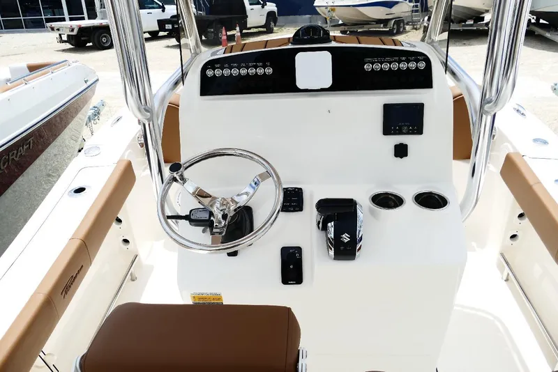 Slide: The Image of 2026 Pioneer 220 Bay Sport boat console with steering wheel and controls. - 43