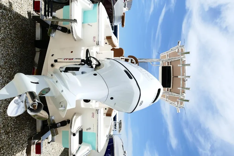 Slide: The Image of 2026 Pioneer 220 Bay Sport boat with powerful outboard motor, viewed from the rear. - 49