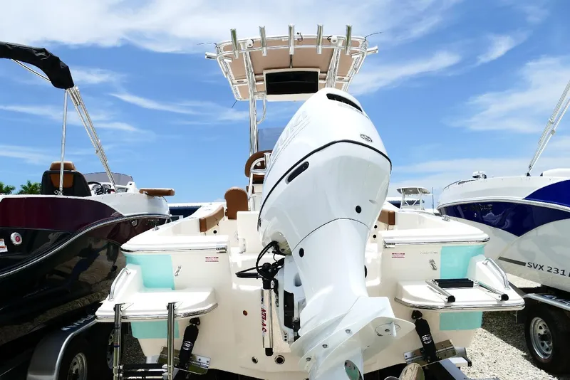 Slide: The Image of 2026 Pioneer 220 Bay Sport boat with powerful outboard motor, displayed outdoors. - 50