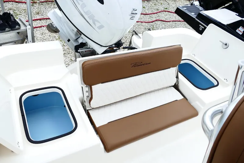 Slide: The Image of 2026 Pioneer 220 Bay Sport boat interior with Suzuki engine and storage compartments. - 7