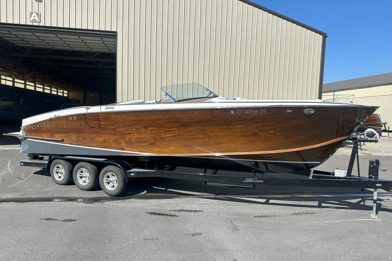 The Image of 2017 StanCraft 320 Rivelle boat on trailer, showcasing sleek wooden design. - 1