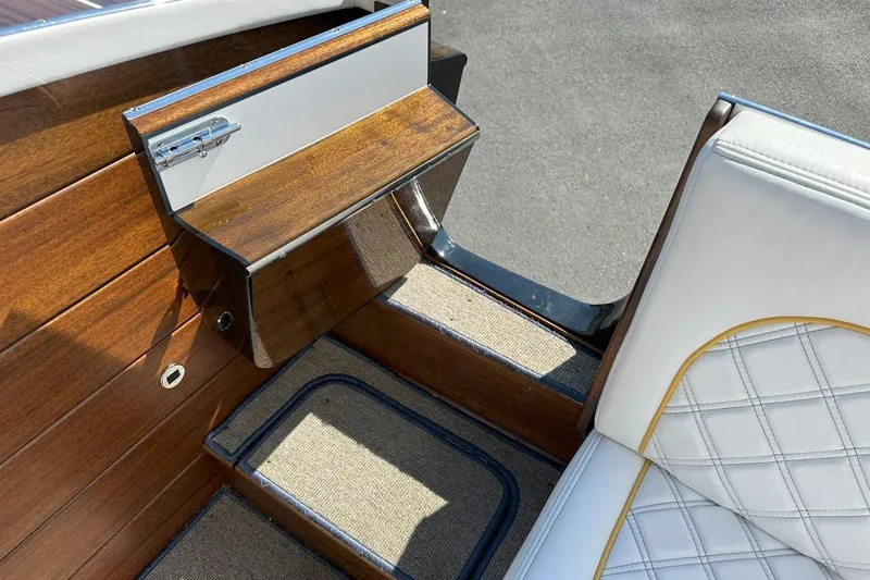Slide: The Image of Interior of 2017 StanCraft 320 Rivelle boat with wood paneling and white quilted seating. - 12