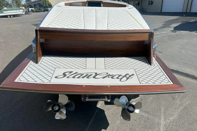 Slide: The Image of 2017 StanCraft 320 Rivelle boat with elegant wood finish and dual propellers. - 3