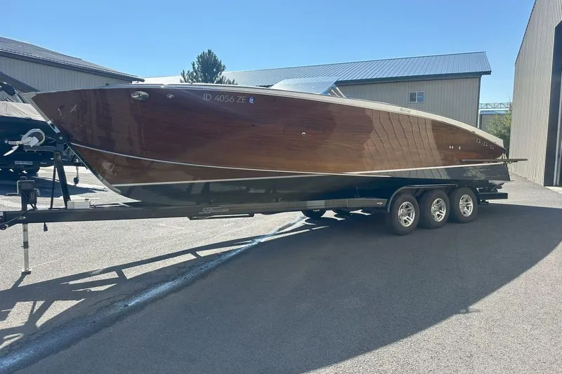 Slide: The Image of 2017 StanCraft 320 Rivelle boat on trailer, showcasing sleek wooden design. - 4