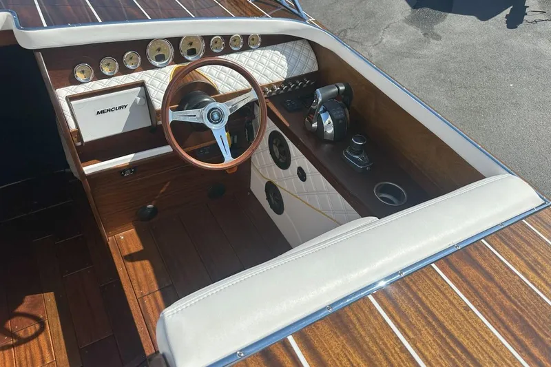 Slide: The Image of 2017 StanCraft 320 Rivelle boat interior with wooden dashboard and Mercury controls. - 5
