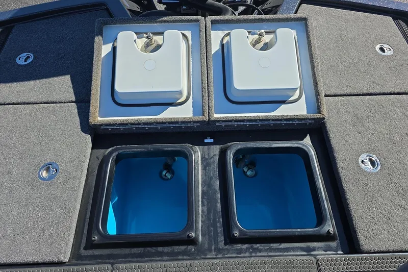 Slide: The Image of 2025 iKon VLX 21 boat deck with open storage compartments and livewells. - 11