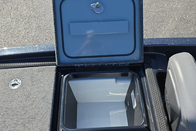 Slide: The Image of Open storage compartment in 2025 iKon VLX 21 boat, featuring secure latch and spacious interior. - 14