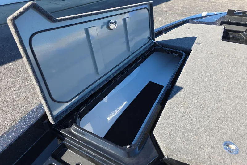 Slide: The Image of Open storage compartment on 2025 iKon VLX 21 boat, featuring carpeted interior. - 17