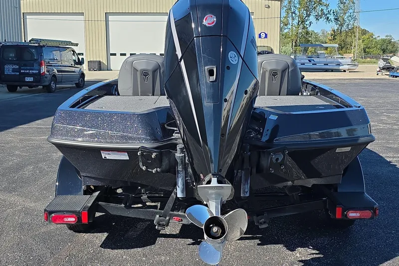 Slide: The Image of 2025 iKon VLX 21 boat with powerful outboard motor, parked outdoors. - 4