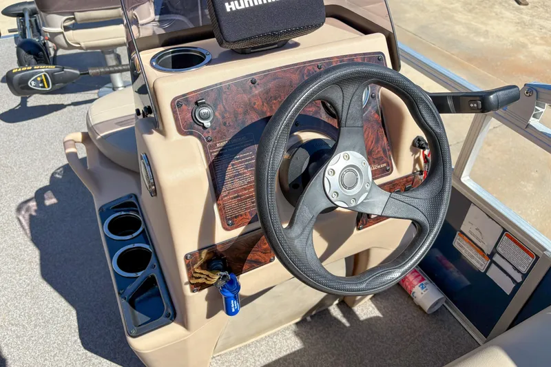 Slide: The Image of 2019 Sun Tracker Bass Buggy 16 DLX steering console with cup holders and control panel. - 12