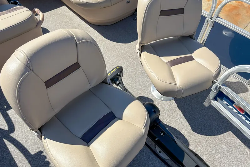 Slide: The Image of 2019 Sun Tracker Bass Buggy 16 DLX boat seats, beige upholstery, and carpeted deck. - 6