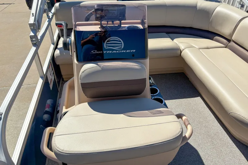 Slide: The Image of 2019 Sun Tracker Bass Buggy 16 DLX interior with beige seating and steering console. - 7