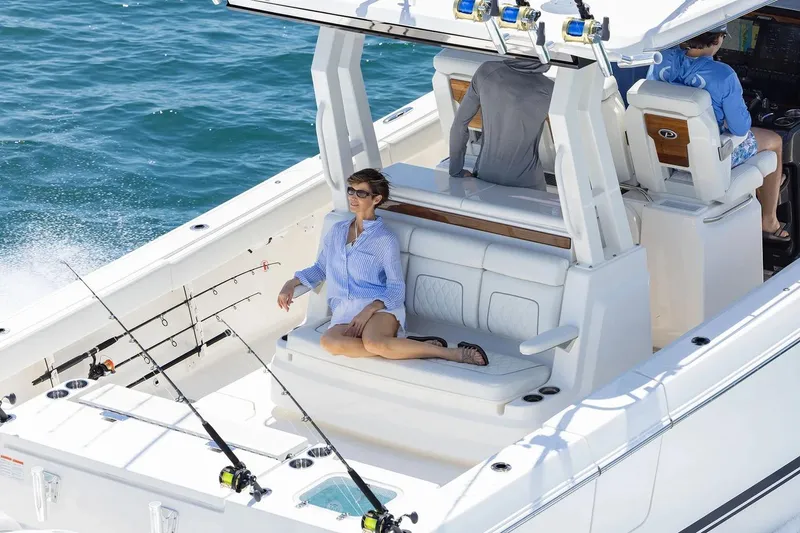 Slide: The Image of Manufacturer Provided Image: 2026 Pursuit S 388 Sport boat cruising with passengers, featuring fishing rods and comfortable seating. - 3