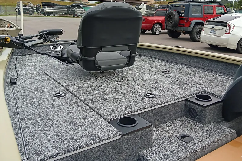 Slide: The Image of 2026 Tracker Pro Team 175 boat interior with gray carpet and swivel seat. - 11