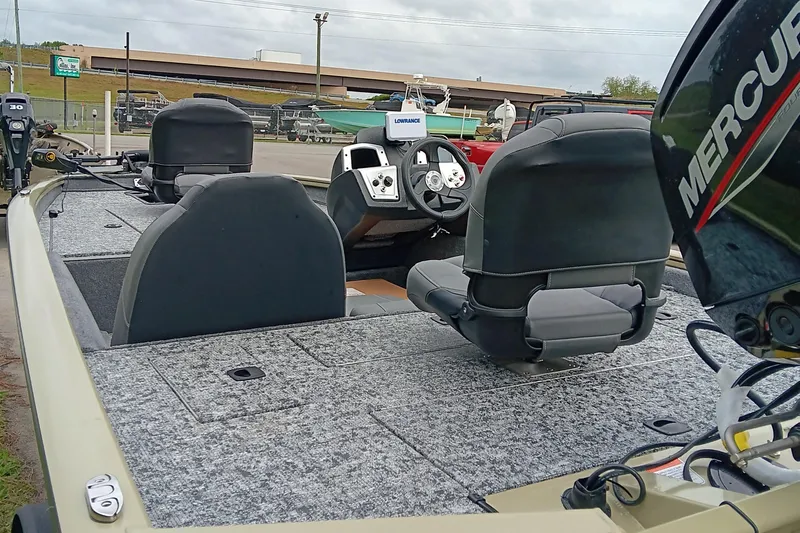 Slide: The Image of 2026 Tracker Pro Team 175 boat interior with steering wheel and Mercury engine. - 14