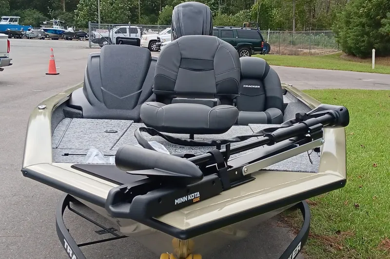 Slide: The Image of 2026 Tracker Pro Team 175 boat with Minn Kota trolling motor, parked outdoors. - 9