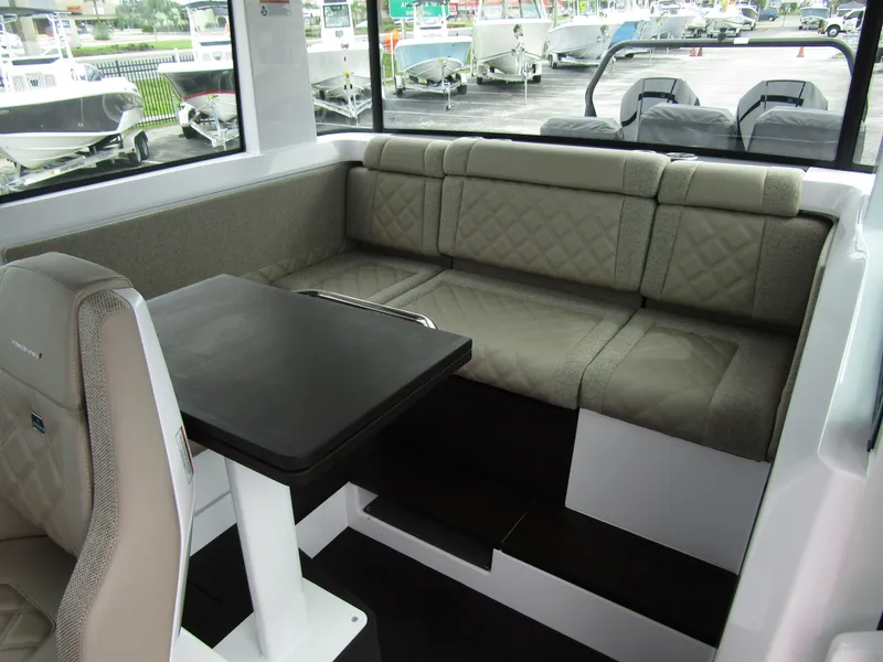 Slide: The Image of 2024 Axopar 37XC CROSS CABIN interior with seating and table. - 14