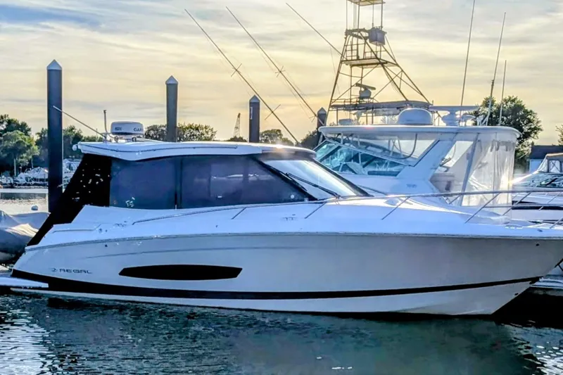 The Image of 2021 Regal 36 Grande Coupe yacht docked at marina, side view. - 0