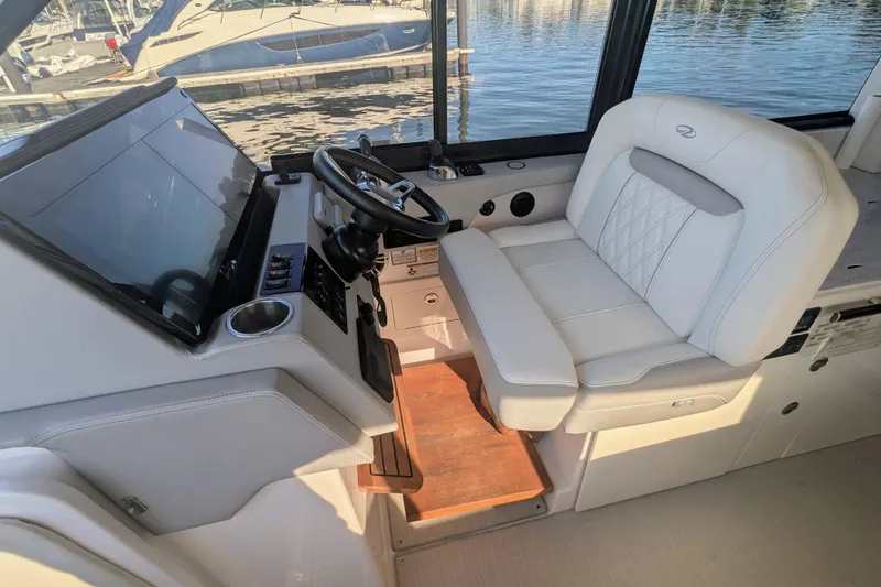 Slide: The Image of 2021 Regal 36 Grande Coupe helm with steering wheel and controls, docked at marina. - 17
