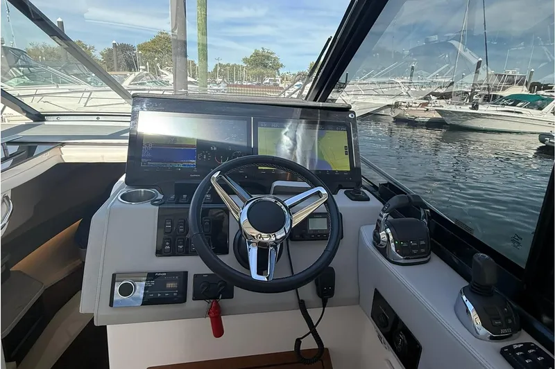 Slide: The Image of Helm of 2021 Regal 36 Grande Coupe with dual Garmin displays and steering wheel. - 19
