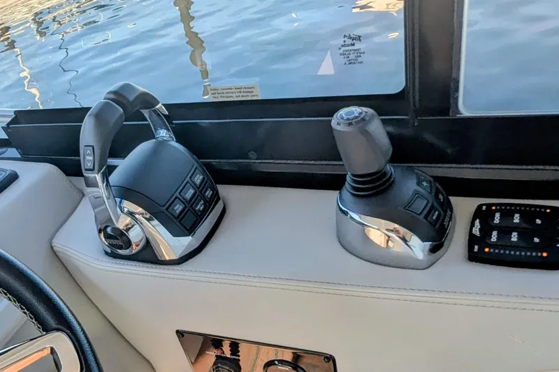 Slide: The Image of Helm of 2021 Regal 36 Grande Coupe with modern navigation displays and controls. - 20