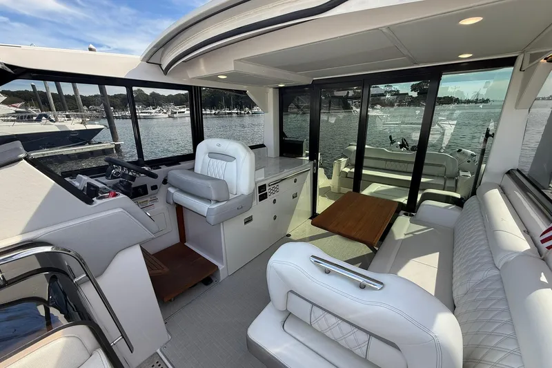 Slide: The Image of Interior of 2021 Regal 36 Grande Coupe yacht with luxurious seating and kitchenette. - 22