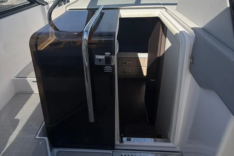 Slide: The Image of Luxurious interior of 2021 Regal 36 Grande Coupe with white seating and wooden table. - 28