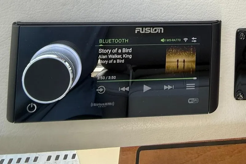 Slide: The Image of Garmin marine radio on 2021 Regal 36 Grande Coupe dashboard, featuring control buttons and display. - 31