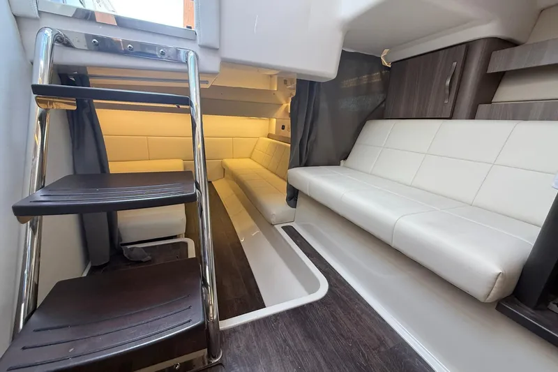 Slide: The Image of 2021 Regal 36 Grande Coupe interior with sofa, microwave, and wood cabinetry. - 37