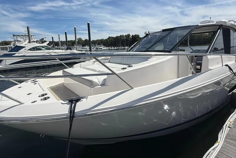 Slide: The Image of 2021 Regal 36 Grande Coupe yacht interior with open roof, docked on a serene lake. - 4