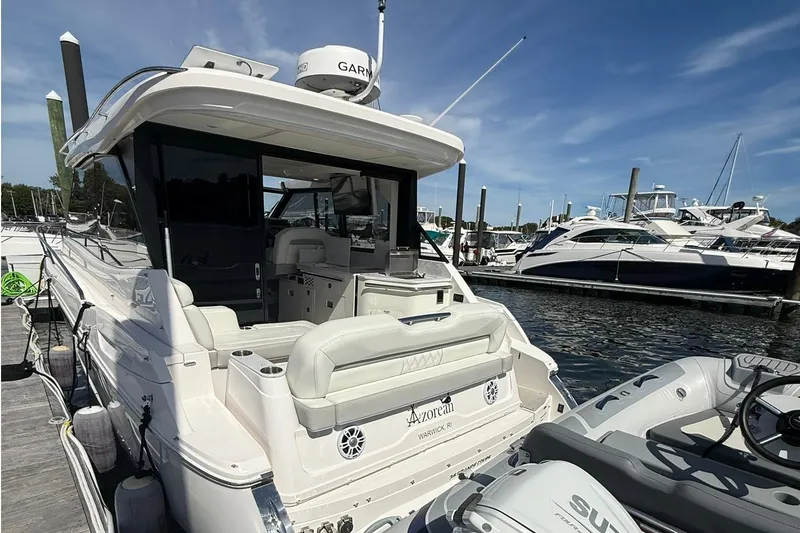 Slide: The Image of 2021 Regal 36 Grande Coupe boat with spacious white sunbed and cup holders. - 6