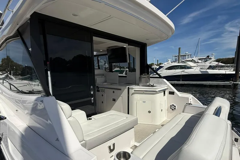 Slide: The Image of 2021 Regal 36 Grande Coupe yacht docked at marina, rear view. - 7