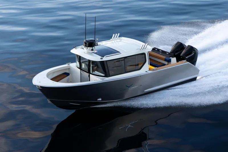 Slide: The Image of 2026 Jasper Marine Defender 22 boat cruising on calm water, showcasing sleek design and powerful engines. - 24