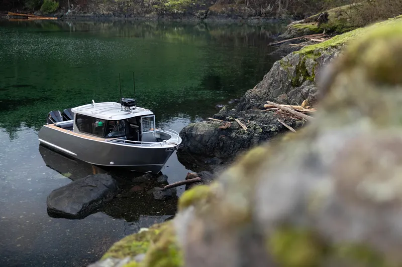 Slide: The Image of 2026 Jasper Marine Defender 22 cruising on calm blue waters. - 3